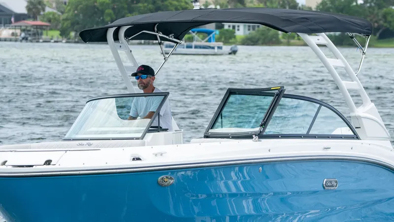 Slide: The Image of 2026 Sea Ray SDX 230 Outboard on a lake with driver. - 5