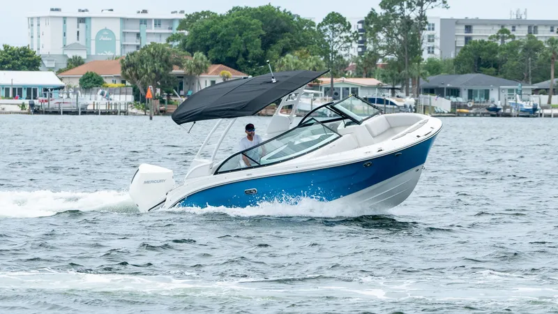 Slide: The Image of 2026 Sea Ray SDX 230 Outboard on water, blue and white design. - 6