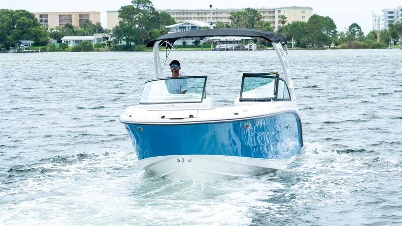 Slide: The Image of 2026 Sea Ray SDX 230 Outboard on water, blue and white design. - 7
