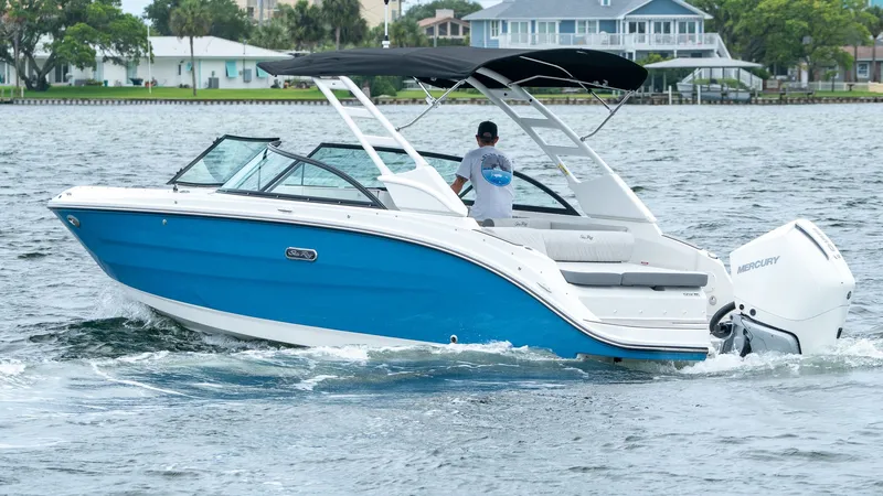 Slide: The Image of 2026 Sea Ray SDX 230 Outboard on water, blue and white design. - 9