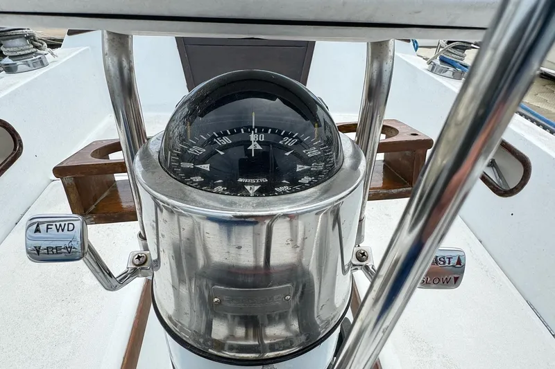 Slide: The Image of Compass and controls on a 1986 Catalina 38 sailboat cockpit. - 14