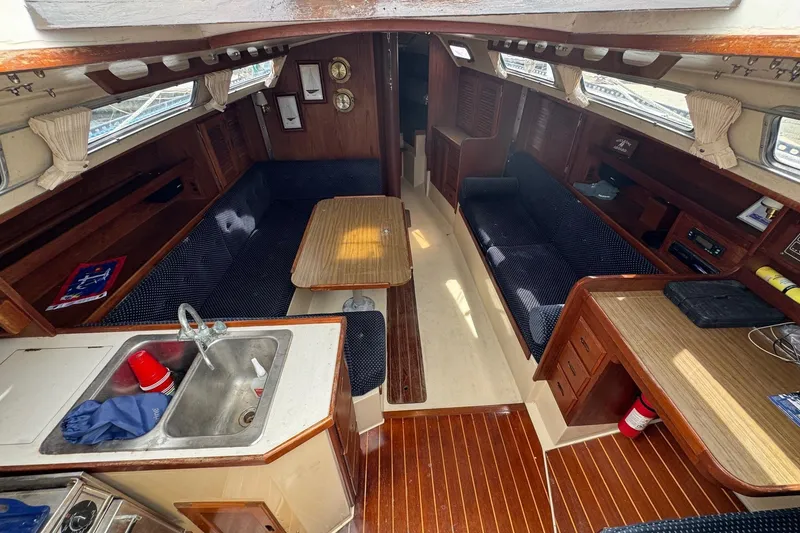 Slide: The Image of Interior of a 1986 Catalina 38 sailboat with wood finishes and seating area. - 17