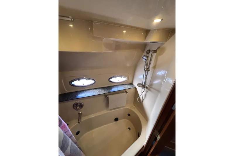 Slide: The Image of Luxurious bathroom in 2005 Cruisers Yachts 455 Express Motoryacht with Jacuzzi Tub/Shower and twin portholes. - 28