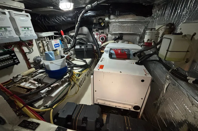 Slide: The Image of Forward Mechanical room of 2005 Cruisers Yachts 455 Express Motoryacht with equipment and wiring and Generator in Sound Shield. - 32