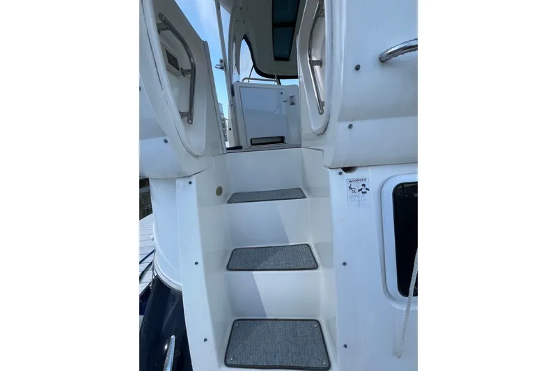 Slide: The Image of 2005 Cruisers Yachts 455 Express Motoryacht  boarding steps to aft deck with hand rails and light switch. - 4