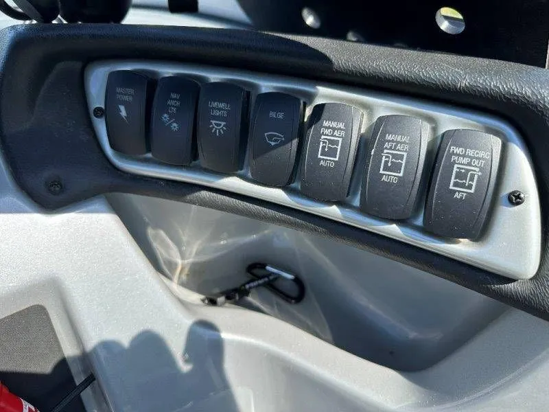 Slide: The Image of Control panel of a 2019 Tracker Targa V18 with various switches. - 25