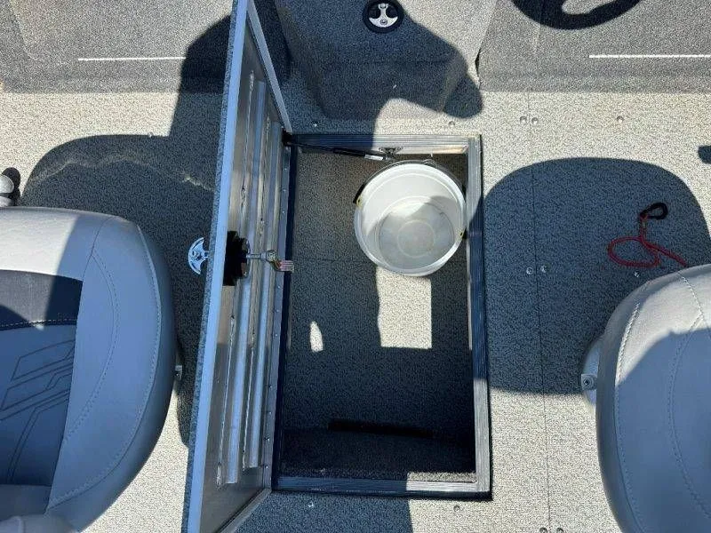 Slide: The Image of 2019 Tracker Targa V18 boat with open storage compartment and bucket. - 29