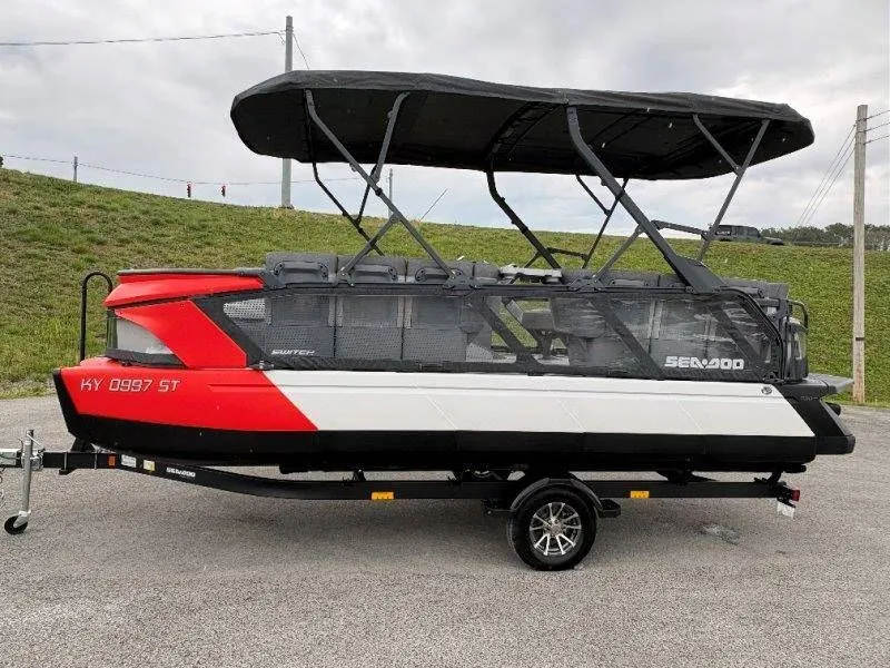 Slide: The Image of 2023 Sea-Doo Switch Cruise 21 on trailer, red and white design. - 18