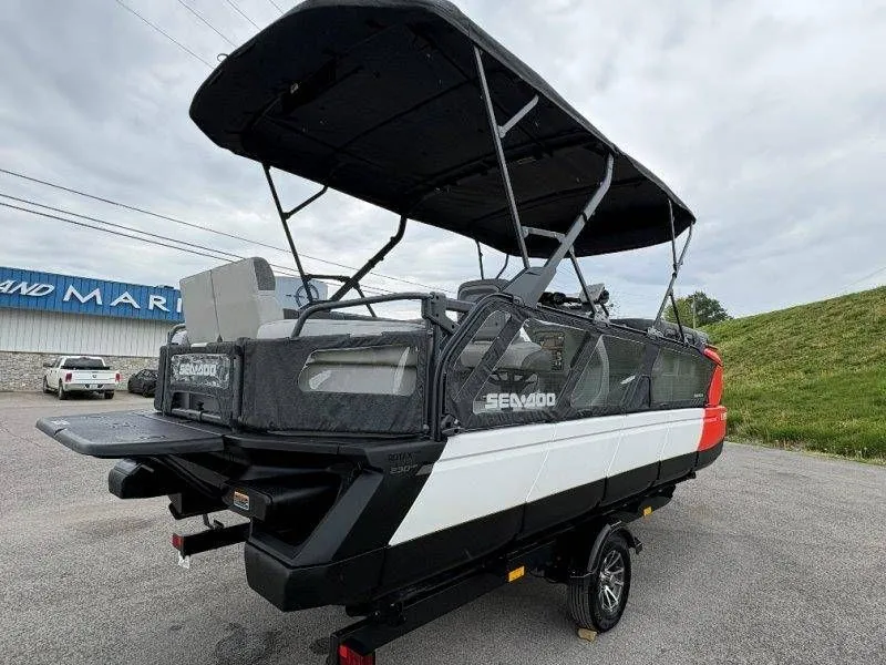 Slide: The Image of 2023 Sea-Doo Switch Cruise 21 with black canopy on trailer. - 20