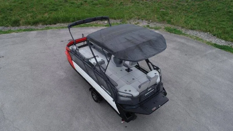 Slide: The Image of 2023 Sea-Doo Switch Cruise 21 pontoon boat with canopy on asphalt. - 5