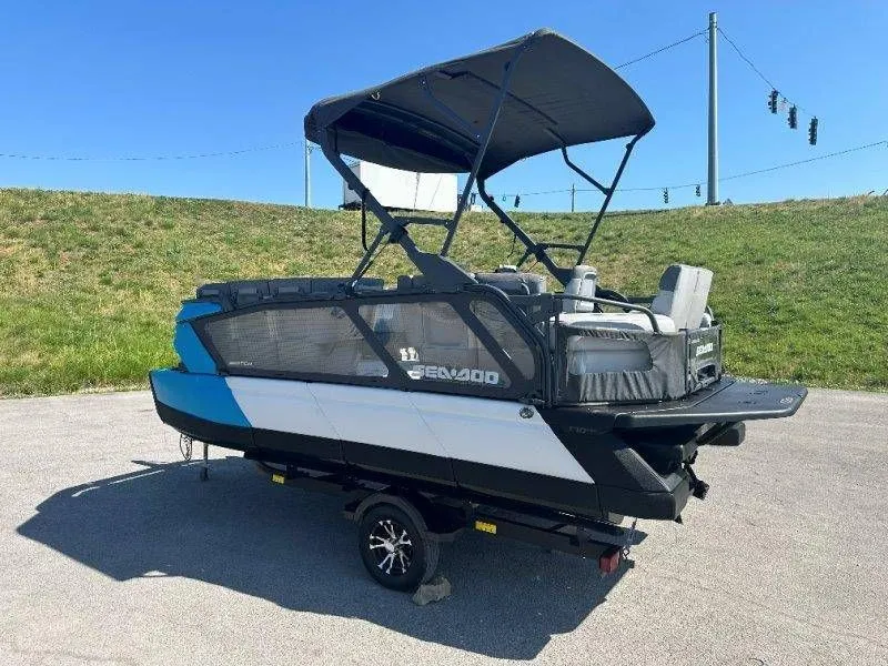 Slide: The Image of 2022 Sea-Doo Switch Cruise 18 on trailer, blue sky, green hill. - 15