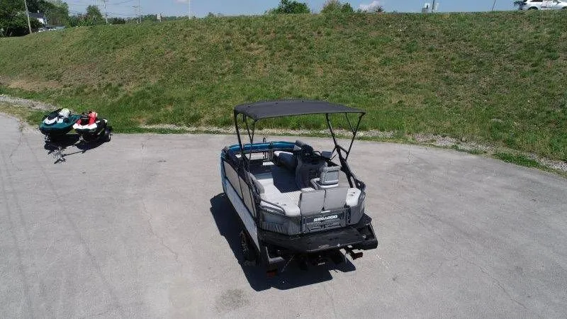 Slide: The Image of 2022 Sea-Doo Switch Cruise 18 on parking lot with jet skis. - 3
