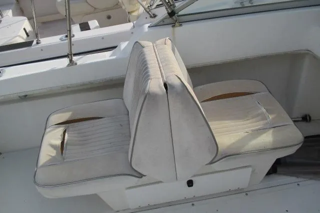 Slide: The Image of 1999 Boston Whaler 20 Ventura Bowrider interior seating, featuring dual white cushioned seats. - 3