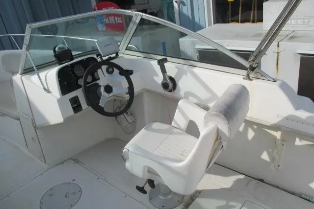Slide: The Image of 1999 Boston Whaler 20 Ventura Bowrider cockpit with steering wheel and seating. - 4