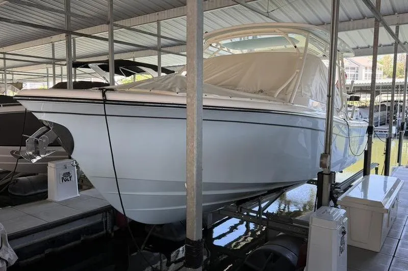 The Image of 2026 Grady-White Freedom 285 boat docked in a covered marina. - 1