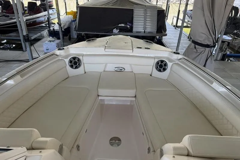 Slide: The Image of 2026 Grady-White Freedom 285 boat interior with beige seating and speakers. - 11