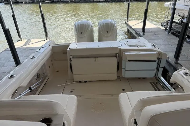 Slide: The Image of 2026 Grady-White Freedom 285 boat interior with dual engines at dock. - 14