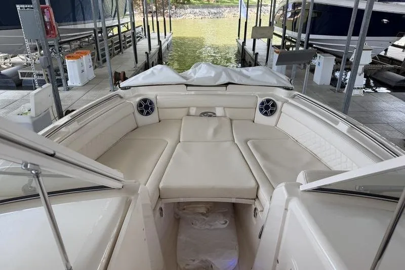Slide: The Image of 2026 Grady-White Freedom 285 boat interior with beige seating and speakers at dock. - 15