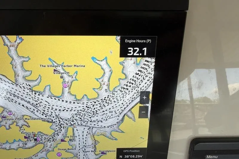Slide: The Image of Navigation display on Grady-White Freedom 285, showing engine hours and marina map. - 18