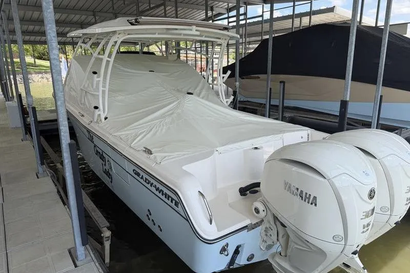 Slide: The Image of 2026 Grady-White Freedom 285 boat with Yamaha engines, docked and covered. - 22