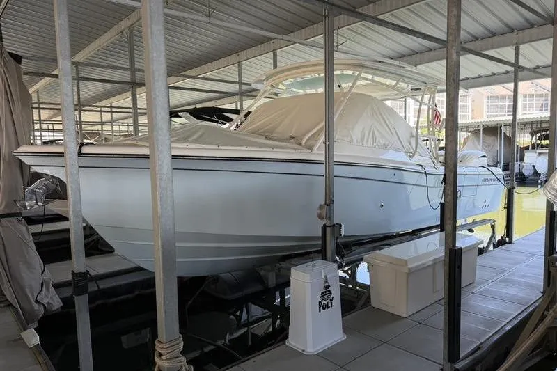 Slide: The Image of 2026 Grady-White Freedom 285 boat docked in a covered marina. - 4