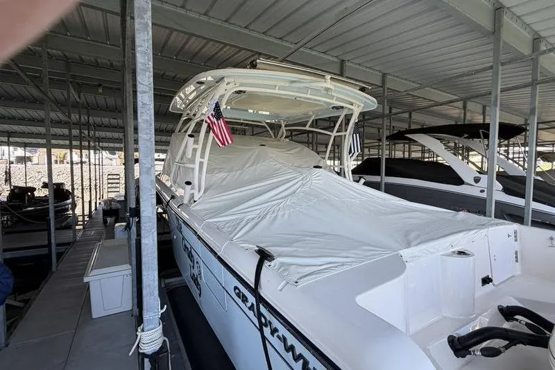 Slide: The Image of 2026 Grady-White Freedom 285 boat docked under a covered marina. - 6