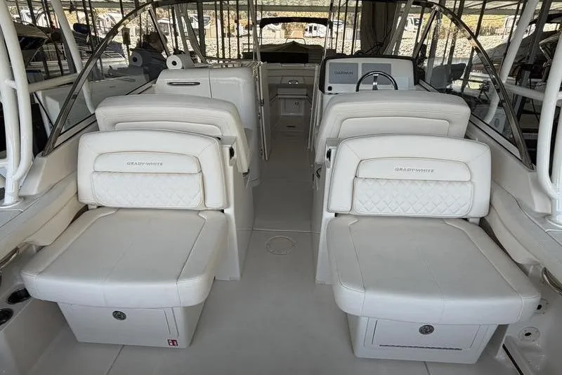 Slide: The Image of 2026 Grady-White Freedom 285 boat interior with luxurious white seating and helm. - 8