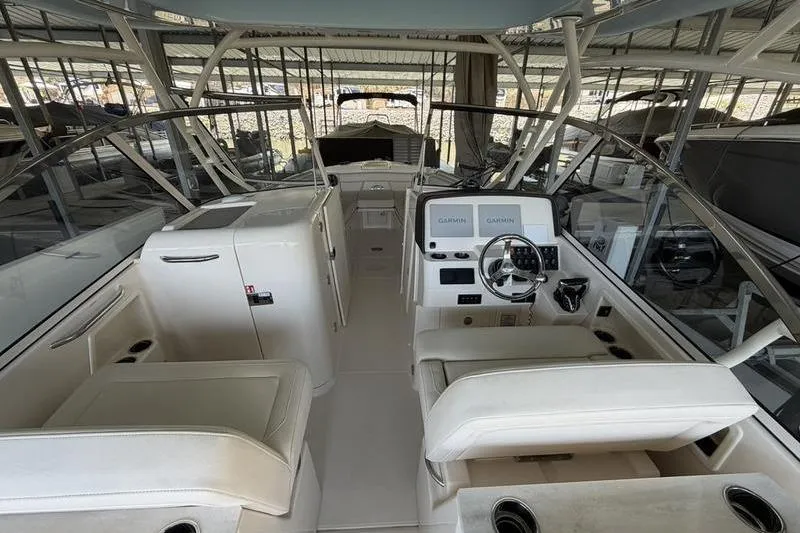 Slide: The Image of 2026 Grady-White Freedom 285 boat interior with modern helm and seating. - 9