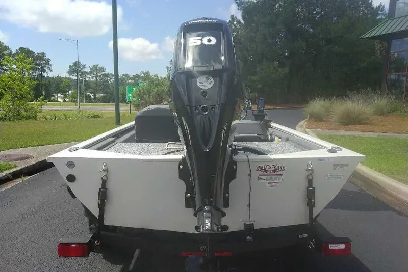 Slide: The Image of 2026 Tracker Pro 170 boat with a 50 HP outboard motor, parked outdoors. - 79