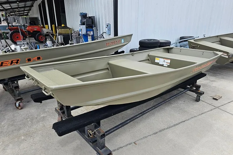 Slide: The Image of 2026 Tracker Grizzly 12 Jon boat displayed in a showroom setting. - 3