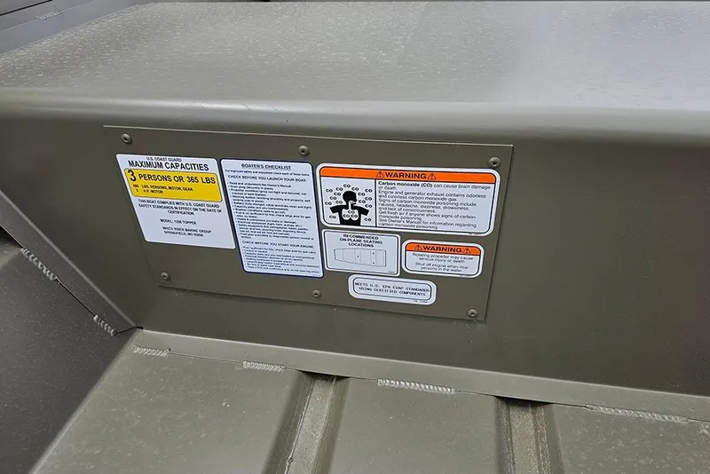 Slide: The Image of Safety labels on 2026 Tracker Grizzly 12 Jon boat, detailing capacity and warnings. - 7