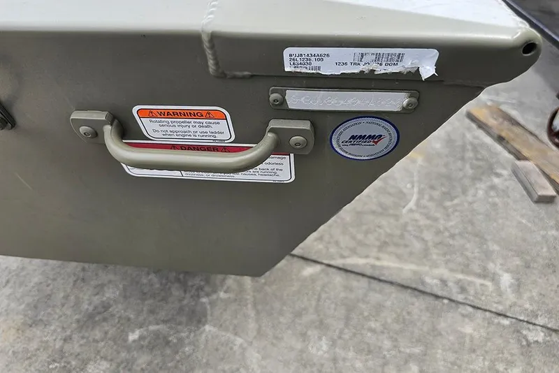 Slide: The Image of 2026 Tracker Grizzly 12 Jon boat stern with warning labels and handle. - 8