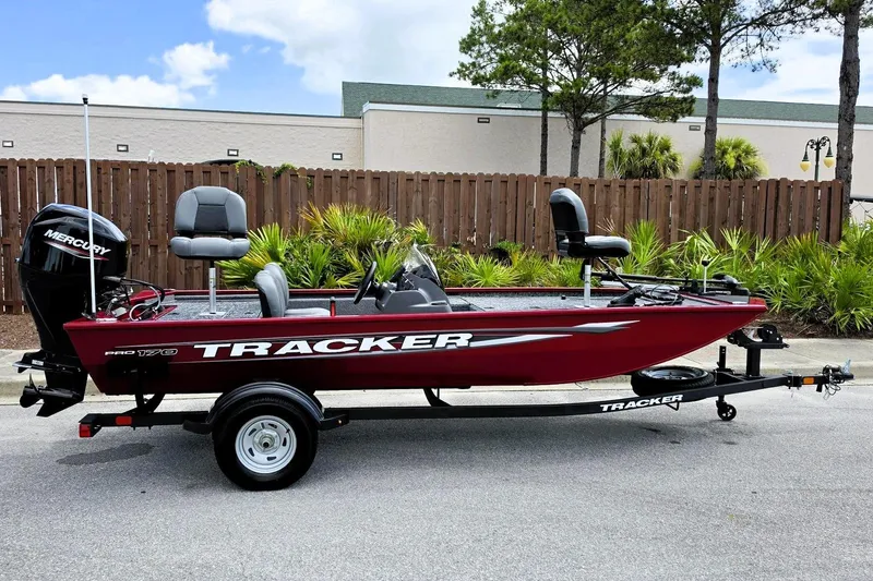The Image of 2026 Tracker Pro 170 boat on trailer, red exterior, parked outdoors. - 0