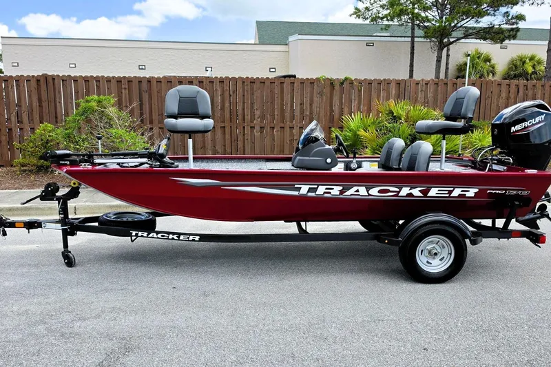 Slide: The Image of 2026 Tracker Pro 170 boat on trailer, red exterior, parked outdoors. - 6