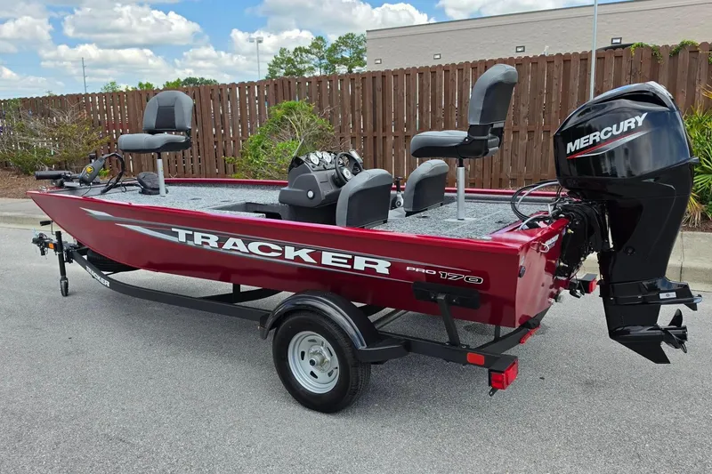 Slide: The Image of 2026 Tracker Pro 170 boat with Mercury outboard motor on trailer, parked outdoors. - 8