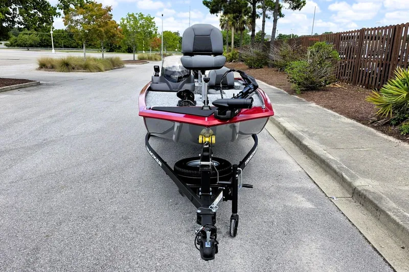 Slide: The Image of 2026 Tracker Pro 170 boat on trailer in parking lot, surrounded by trees. - 9