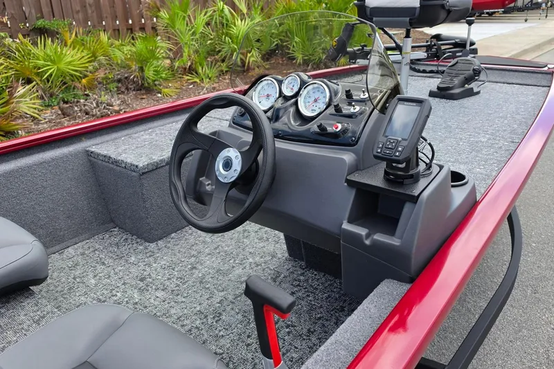 Slide: The Image of 2026 Tracker Pro 170 boat interior with steering wheel, gauges, and navigation system. - 11