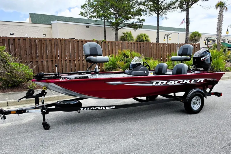 Slide: The Image of 2026 Tracker Pro 170 boat on trailer, red exterior, parked outdoors. - 7