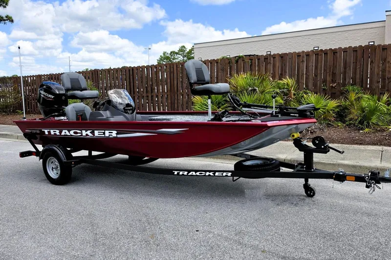 Slide: The Image of 2026 Tracker Pro 170 boat on trailer, red exterior, parked outdoors. - 4