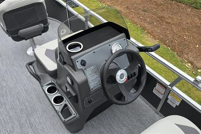 Slide: The Image of 2026 Sun Tracker Bass Buggy 16 XL Select boat console with steering wheel and cup holders. - 9