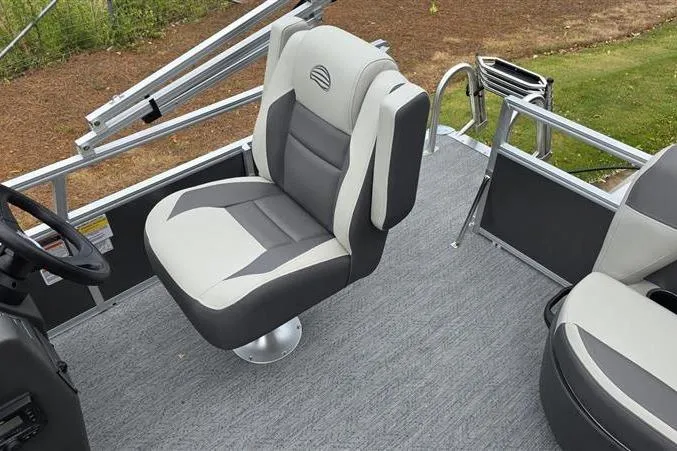 Slide: The Image of 2026 Sun Tracker Bass Buggy 16 XL Select boat seat, gray and white upholstery, on deck. - 10