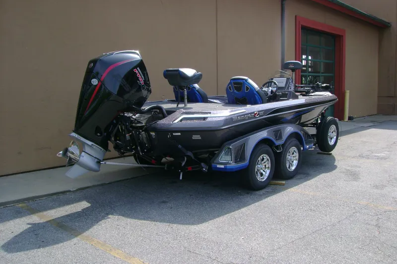 Slide: The Image of 2026 Ranger Z519R Cup-Equipped boat with powerful outboard motor, parked outdoors. - 4
