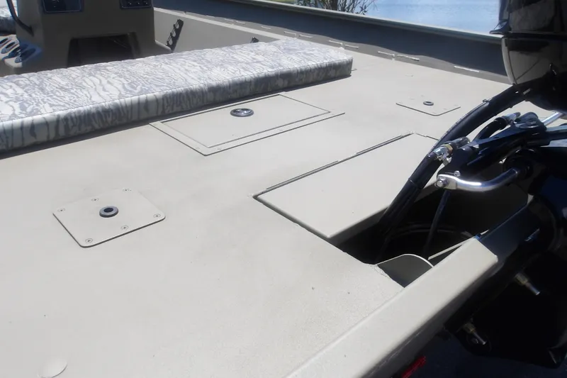 Slide: The Image of 2026 Tracker Grizzly 2072 CC boat deck with storage compartments and motor detail. - 15