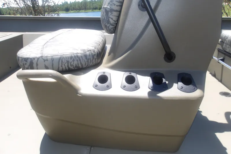 Slide: The Image of 2026 Tracker Grizzly 2072 CC boat seat with rod holders, camo cushion, and sturdy design. - 13