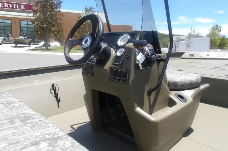 Slide: The Image of 2026 Tracker Grizzly 2072 CC boat interior with steering console and seating. - 6