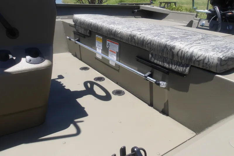 Slide: The Image of Interior of 2026 Tracker Grizzly 2072 CC boat with camo seating and control features. - 14
