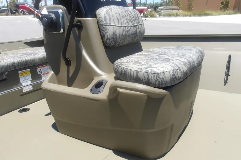 Slide: The Image of 2026 Tracker Grizzly 2072 CC boat seat with camouflage pattern and control panel. - 9