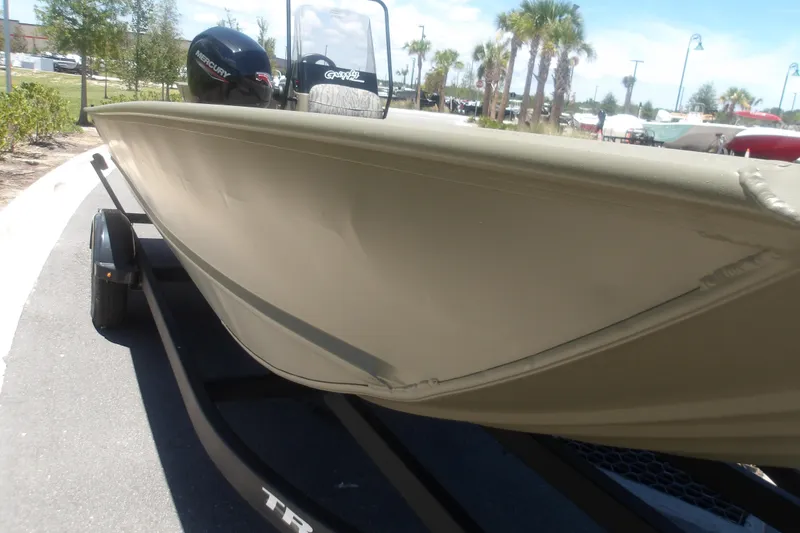 Slide: The Image of 2026 Tracker Grizzly 2072 CC boat on trailer, parked outdoors under clear sky. - 10