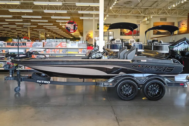 Slide: The Image of 2026 Nitro Z19 XL boat displayed indoors on a trailer in a showroom. - 2