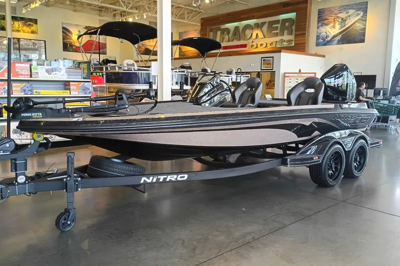 Slide: The Image of 2026 Nitro Z19 XL boat displayed in showroom, featuring sleek design and dual axle trailer. - 1